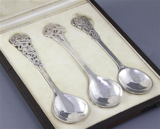 A rare cased set of three George V Arts & Crafts silver spoons, by Omar Ramsden, Length each 162mm total weight 4.8oz/150grms